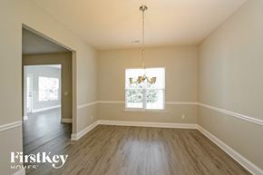 Kernersville house for rent - an empty dining room with wood floors and a window