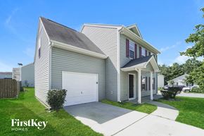Charlotte house for rent - A house with a garage and a driveway is shown.