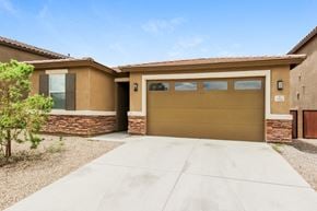 Tucson house for rent - a house with a garage door and a concrete driveway
