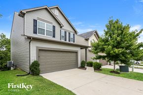 St Peters house for rent - a gray house with a garage door and a driveway