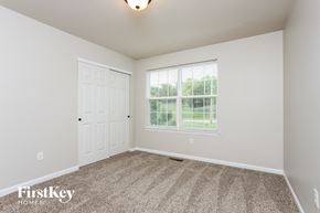 St Peters house for rent - a bedroom with carpet and a white door and window