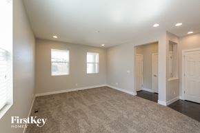 Denver house for rent - a living room with carpet and white doors and windows