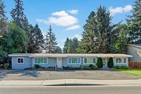 Issaquah apartment for rent - a blue house with a driveway and trees