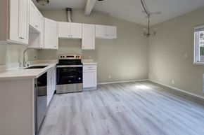 Issaquah apartment for rent - an empty kitchen with white cabinets and stainless steel appliances