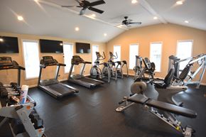 Terre Haute triplex for rent - a gym with cardio equipment and flat screen tv