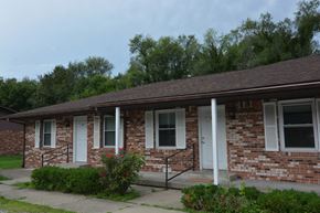 Terre Haute triplex for rent - a brick building with white doors and a porch