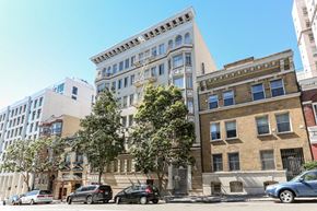 San Francisco apartment for rent - a large building on a city street with cars