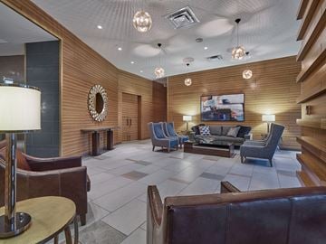 New Brunswick apartment for rent - A living room with a brown couch and a TV on the wall.