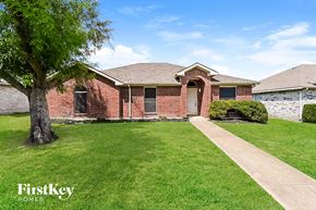 Lancaster house for rent - a brick house with a lawn and a tree