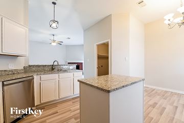 Lancaster house for rent - a kitchen with granite counter tops and white cabinets