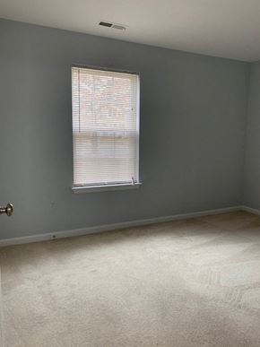 Laurel apartment for rent - A room with a carpeted floor and a window with blinds.