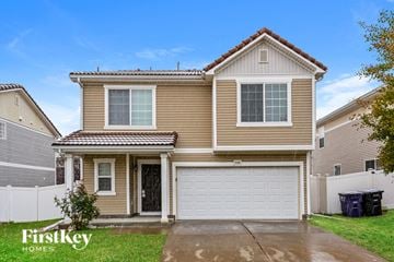 Denver house for rent - a yellow house with a white garage door