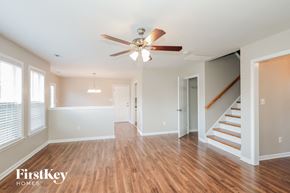 Mount Holly house for rent - an empty living room with a ceiling fan and stairs