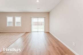 Brookshire house for rent - A room with wooden flooring and a sliding glass door.