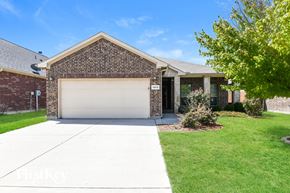 Weatherford house for rent - a garage door in front of a brick house