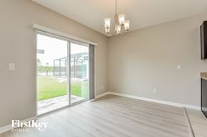 Port Orange house for rent - A room with a sliding glass door leading to a backyard.