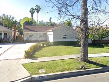 Sherman Oaks apartment for rent - A tree stands in front of a white house with a garage.