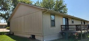 Clinton apartment for rent - the front of a mobile home with a wooden deck