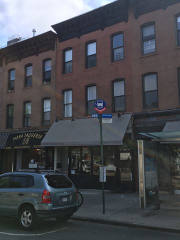Brooklyn apartment for rent - a car parked on the street in front of a building