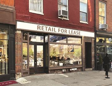 New York apartment for rent - a retail for lease sign on the front of a building
