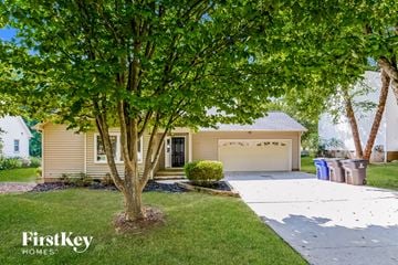 Kernersville house for rent - a yellow house with a driveway and a tree