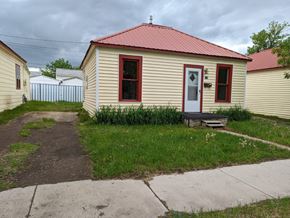 Great Falls apartment for rent - a small yellow house with a red roof and a sidewalk