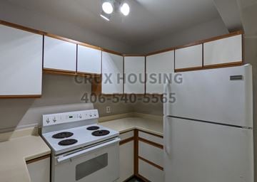 Great Falls apartment for rent - a kitchen with white cabinets and white appliances