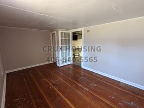 Great Falls apartment for rent - a small living room with a wooden floor and a door to a dining room