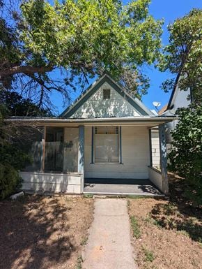 Great Falls house for rent - A small house with a porch and a tree in front.