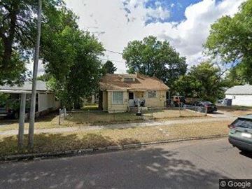 Great Falls house for rent - A house with a brown roof is surrounded by trees and grass.