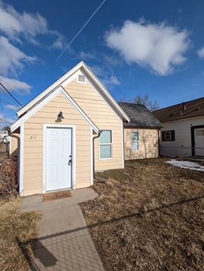 Great Falls house for rent - the front of a small yellow house with a white door