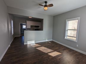 Great Falls house for rent - a living room with wood floors and a ceiling fan