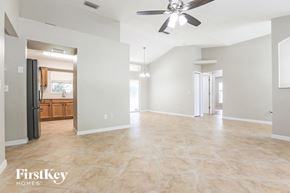 North Port house for rent - an empty kitchen and living room with a ceiling fan