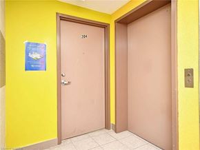 Waterloo apartment for rent - A yellow wall with a brown door and a sign on the wall.