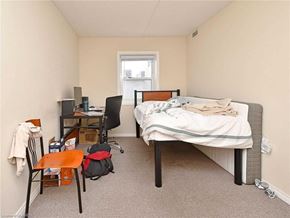 Waterloo apartment for rent - A bedroom with a bed, desk, chair, and a window.