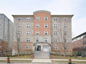 Waterloo apartment for rent - A large building with a red brick facade and a stone archway entrance.