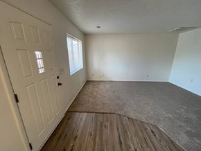 Cottonwood apartment for rent - A room with a white door and a window with blinds.