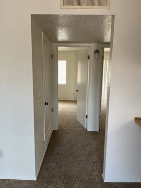 Cottonwood apartment for rent - A hallway with white walls and carpeted floor.