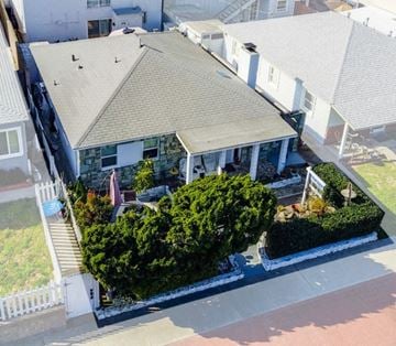 San Diego apartment for rent - an aerial view of a white house with a roof and a porch