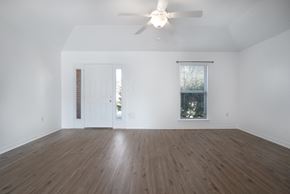 Foley house for rent - A room with a ceiling fan and a window with blinds.
