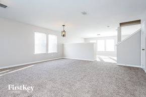 Cedar Hill house for rent - A spacious room with a carpeted floor and a staircase on the right side.