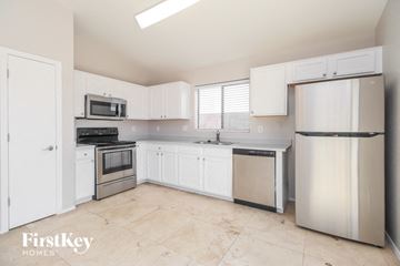 Florence house for rent - a white kitchen with stainless steel appliances and white cabinets