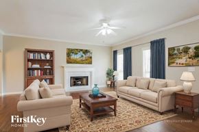 Chelsea house for rent - A living room with a fireplace, two couches, a coffee table, and a bookshelf.