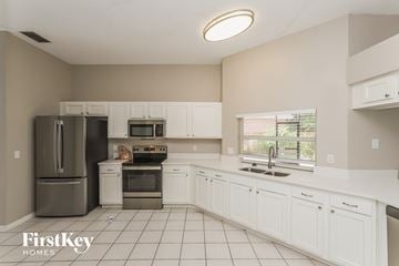 Riverview house for rent - A kitchen with white cabinets and a stainless steel refrigerator.