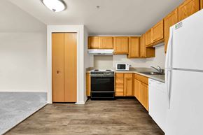 Shelby Township apartment for rent - A kitchen with wooden cabinets and a white refrigerator.