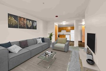 Shelby Township apartment for rent - A living room with a grey couch and a glass coffee table.