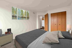 Shelby Township apartment for rent - A bedroom with a large bed and a painting on the wall.