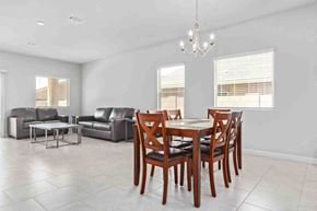 Tucson house for rent - a dining room with a table and chairs and a couch