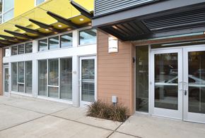 Seattle apartment for rent - A building with a yellow awning and a brown wall.