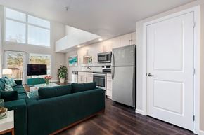 Seattle apartment for rent - A kitchen with a refrigerator, microwave, and oven.